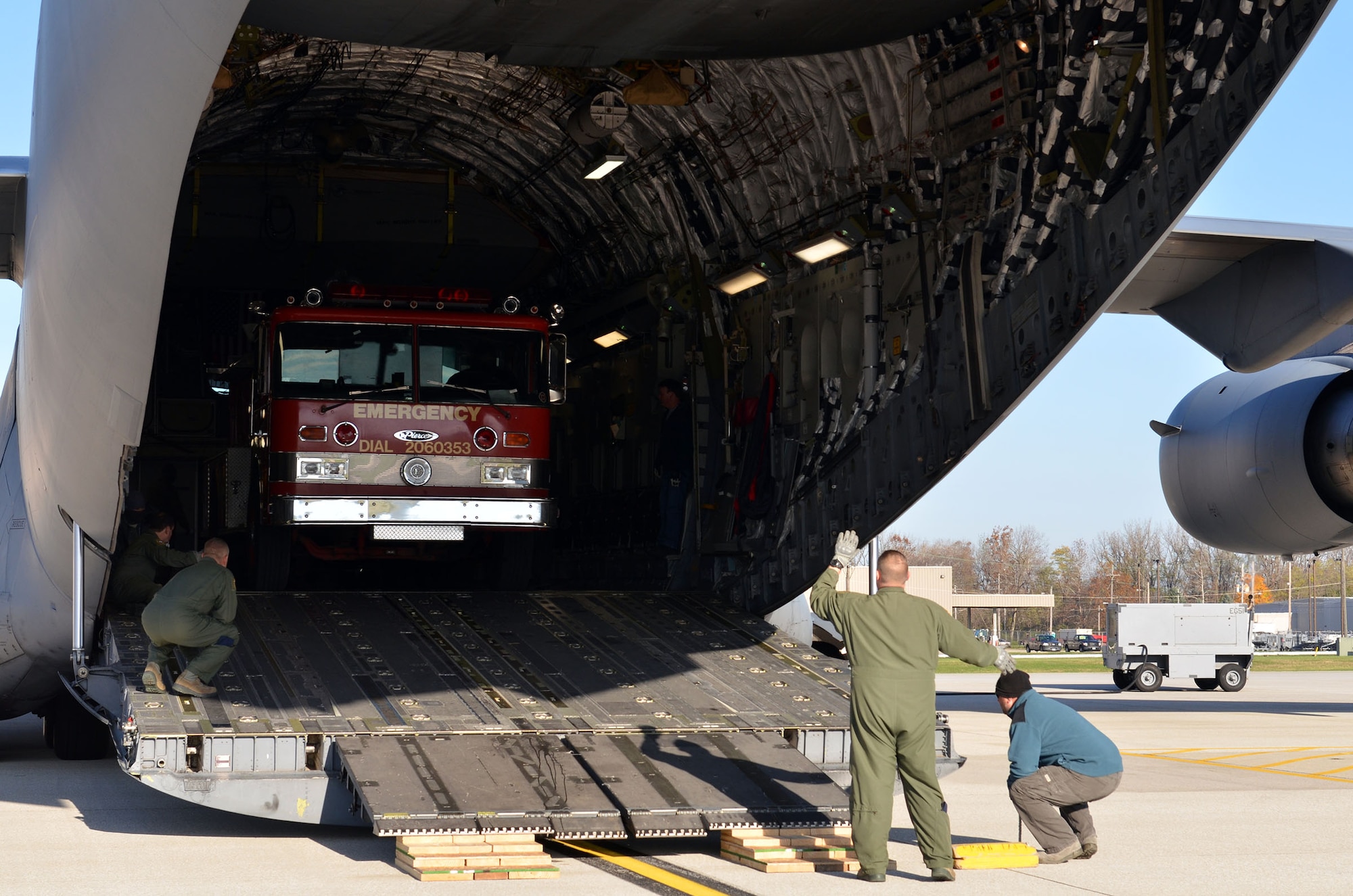 Loadmasters from the 89th Airlift Squadron load a fire truck on a 445th Airlift Wing C-17 Globemaster III Nov. 8, 2017. The wing received a request through the Denton Program to move a fire truck from Ohio to Belize City, Belize.