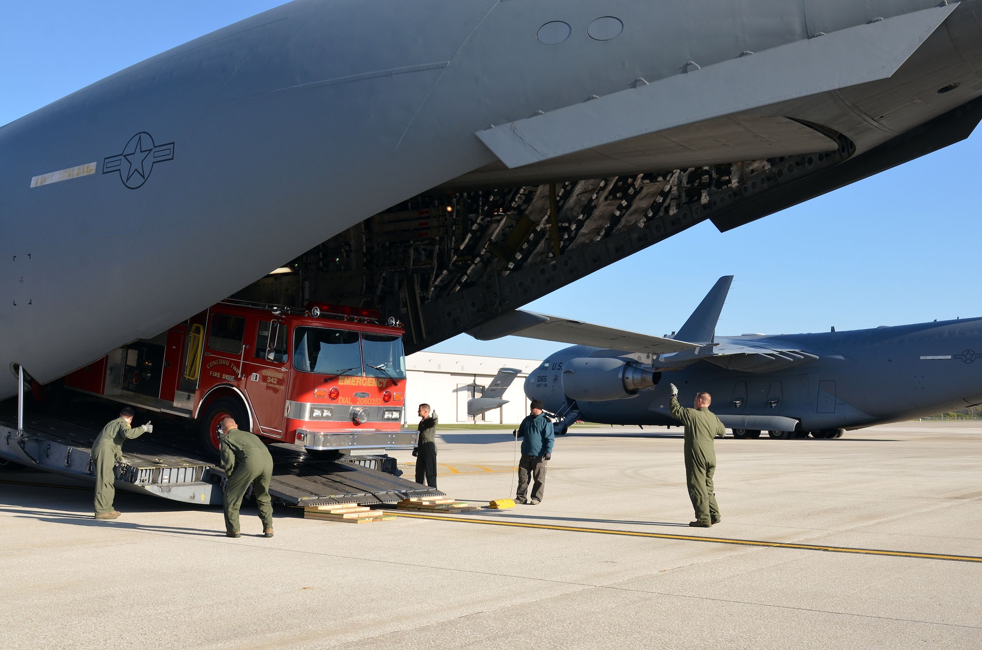 Loadmasters from the 89th Airlift Squadron load a fire truck on a 445th Airlift Wing C-17 Globemaster III Nov. 8, 2017. The wing received a request through the Denton Program to move a fire truck from Ohio to Belize City, Belize.