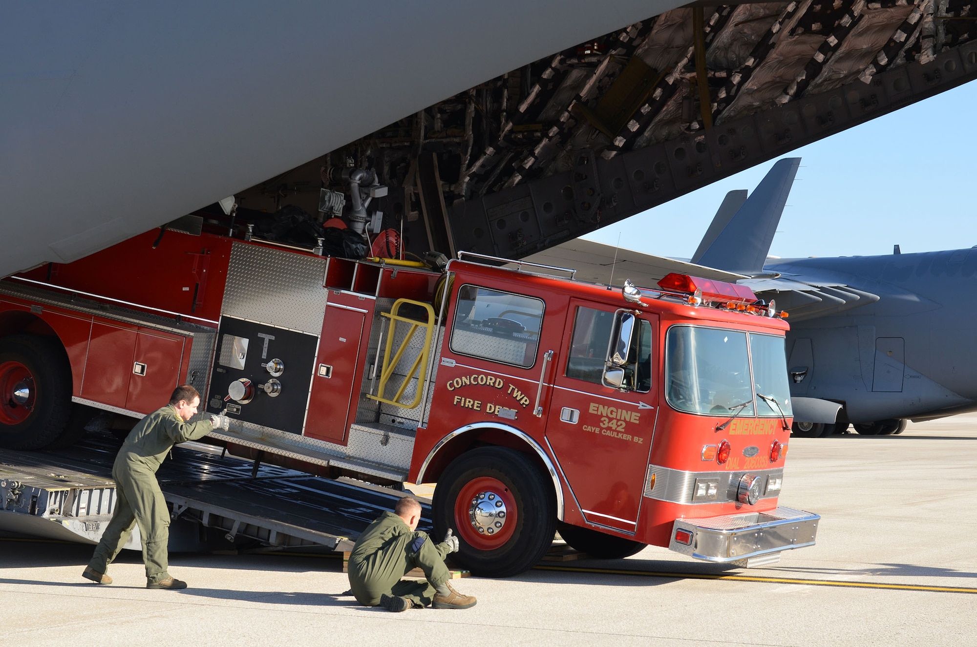 Loadmasters from the 89th Airlift Squadron load a fire truck on a 445th Airlift Wing C-17 Globemaster III Nov. 8, 2017. The wing received a request through the Denton Program to move a fire truck from Ohio to Belize City, Belize.
