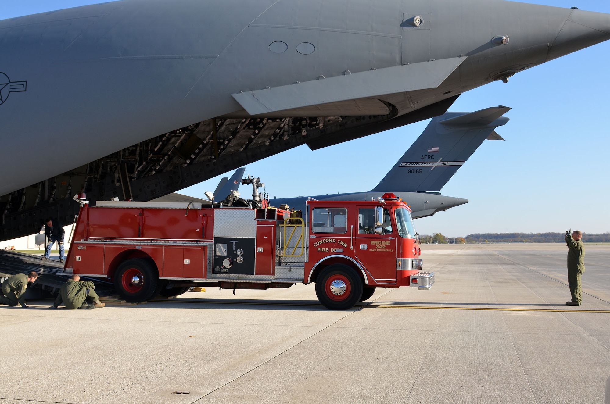 Loadmasters from the 89th Airlift Squadron load a fire truck on a 445th Airlift Wing C-17 Globemaster III Nov. 8, 2017. The wing received a request through the Denton Program to move a fire truck from Ohio to Belize City, Belize.