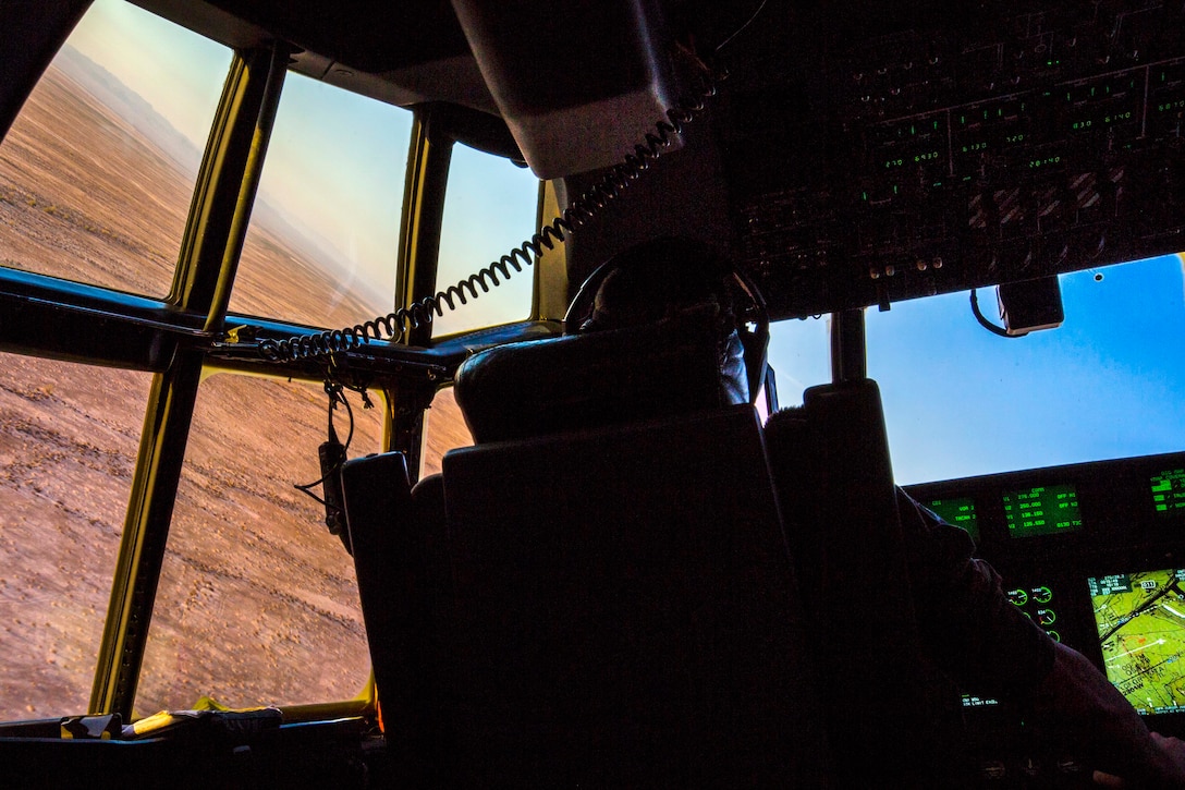 Marine Corps Maj. Matthew Stolzenberg flies a KC130-J Hercules aircraft while conducting tactical navigation training.