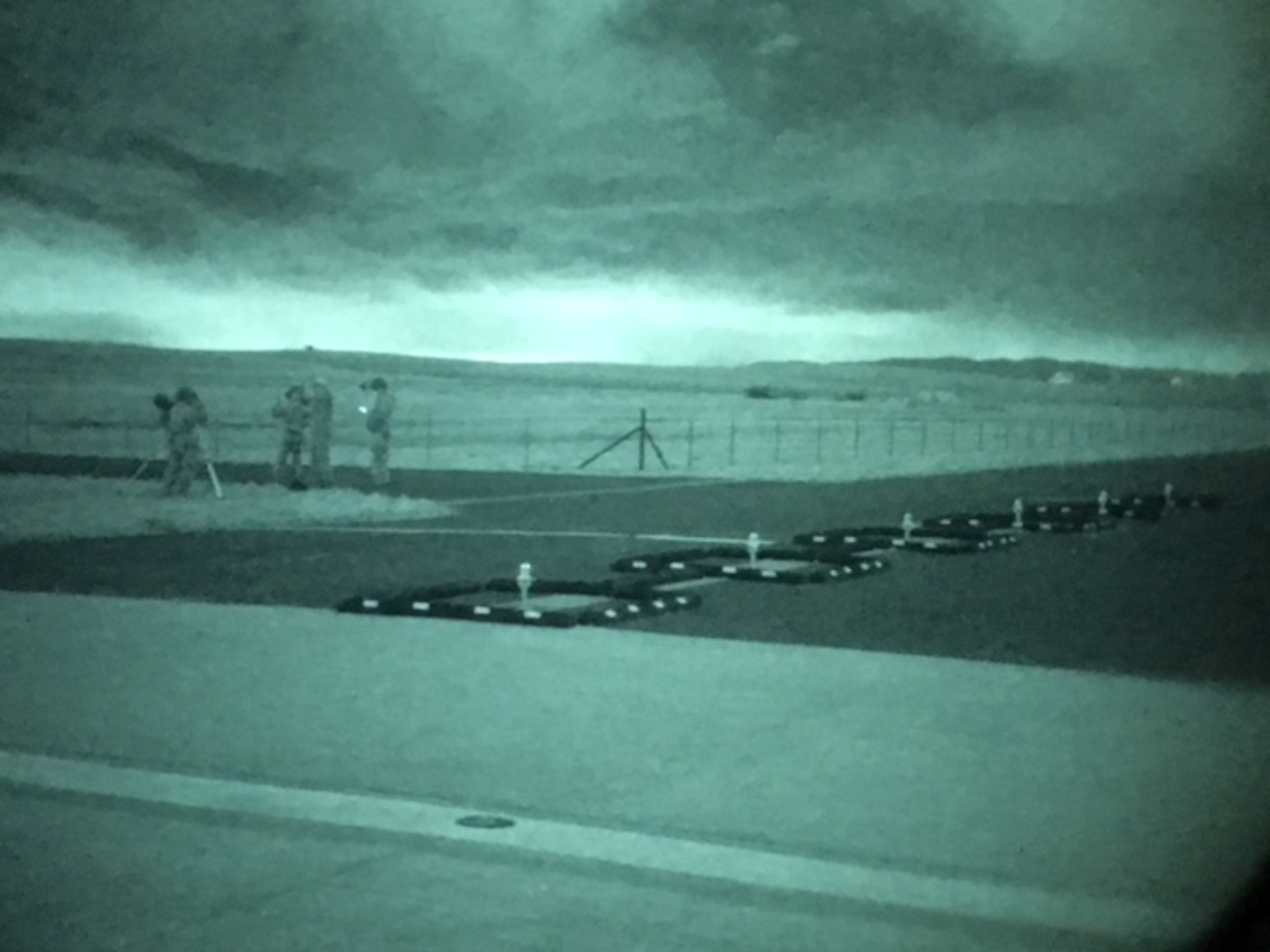 Airmen from the 60th Aerial Port Squadron set up night vision equipment during a recent training event at Travis Air Force Base, Calif. The 60th APS is in the process of transitioning the currently used green phosphor night vision goggles to white and black phosphor NVGs. White and black phosphor NVGs offer modern day technology and enhance mission effectiveness when operating in low-light or no-light conditions.