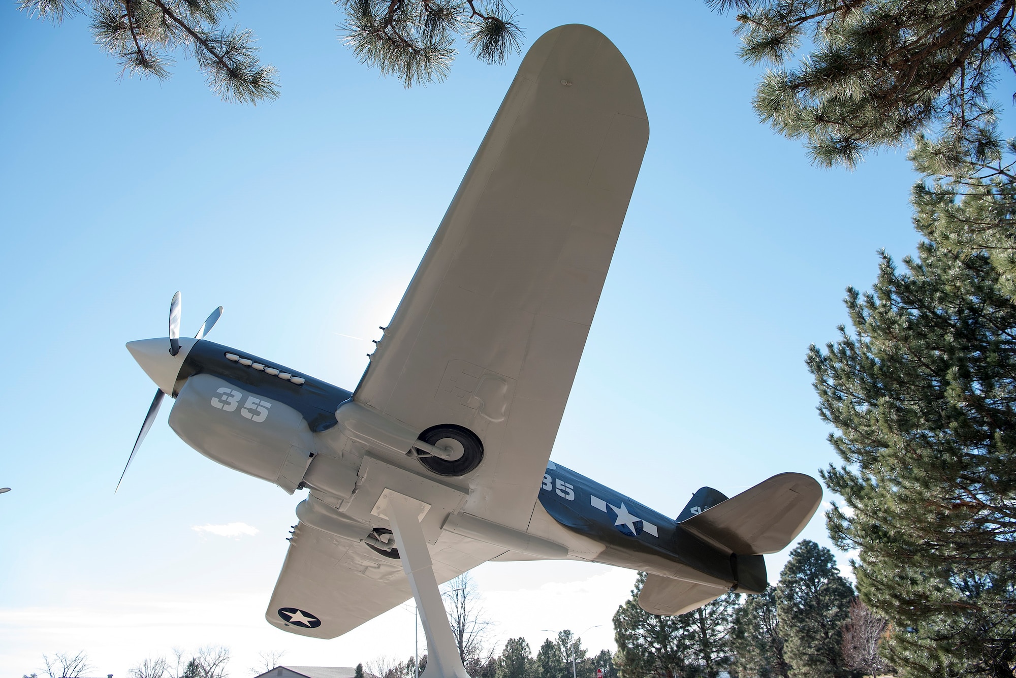A replica Curtiss P-40 Warhawk on display at Peterson Air Force Base, Colorado, Dec. 1, 2017. The replica is on loan from the Wright-Patterson Air Force Museum. It is painted in the livery of the P-40 trainers that were used at Peterson Field in 1944. (U.S. Air Force Photo by Steve Kotecki)