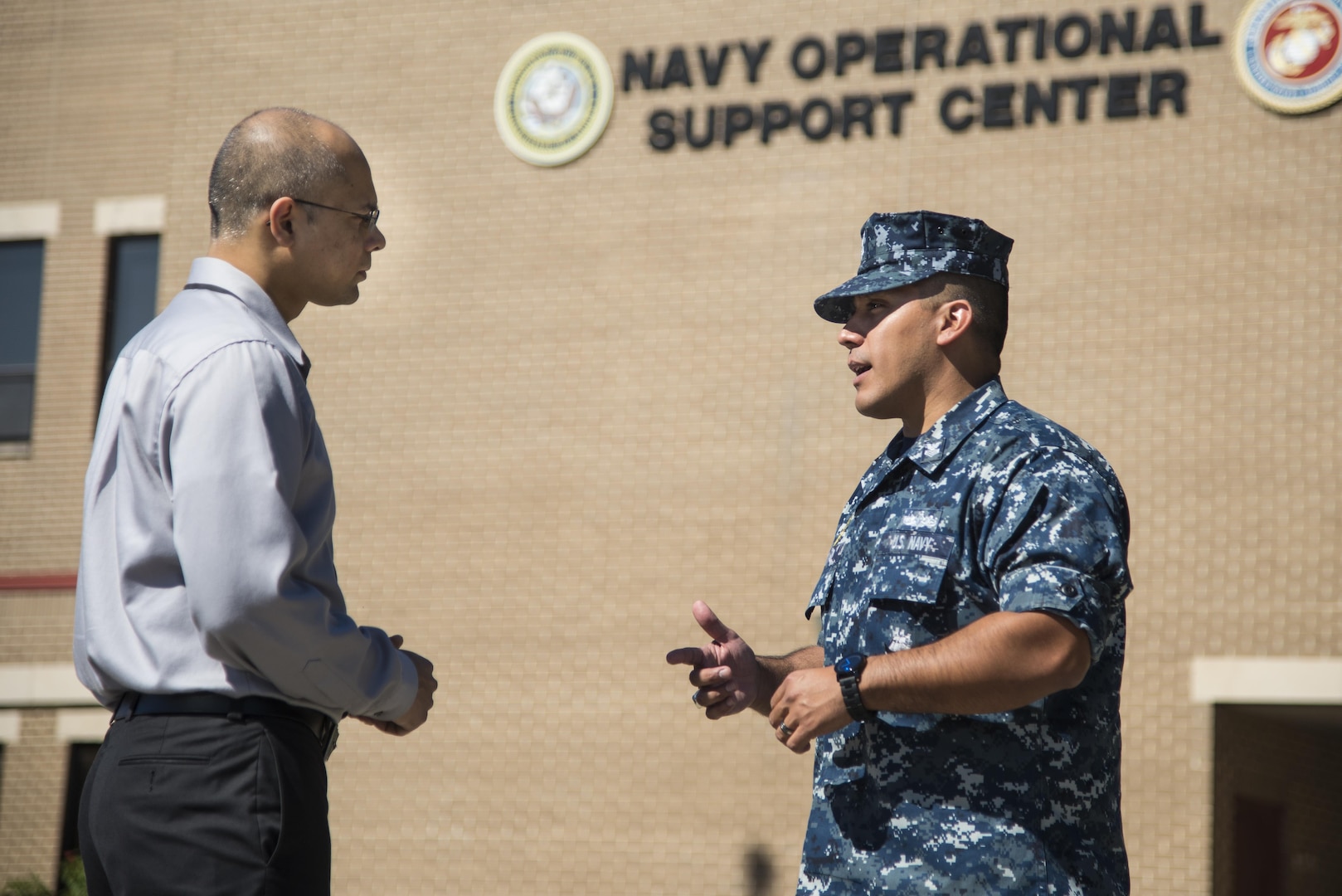 Petty Officer First Class Christopher Thomas, Navy Recruiting District San Antonio recruiter, speaks to an applicant about job opportunities in the Navy Oct. 25, 2017.  Thomas’ mission is to find officer applicants to lead naval forces in conducting operations on land, air and sea.  (U.S. Air Force photo by Sean M. Worrell)