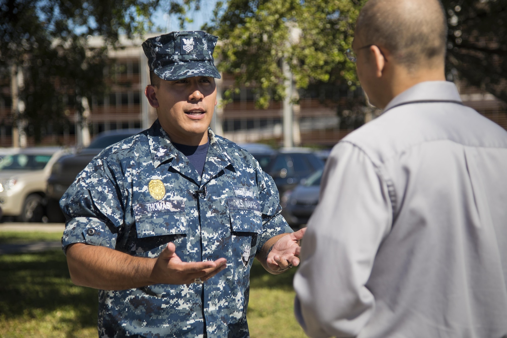 Petty Officer First Class Christopher Thomas, Navy Recruiting District San Antonio recruiter, speaks to an applicant about job opportunities in the Navy Oct. 25, 2017.  Thomas’ mission is to find officer applicants to lead naval forces in conducting operations on land, air and sea.  (U.S. Air Force photo by Sean M. Worrell)