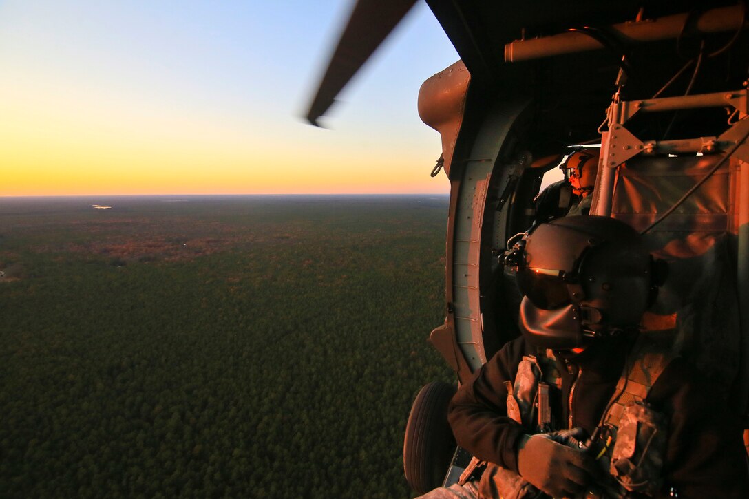 Sgt. Jeff Angle observes the ground from his UH-60 Black Hawk helicopter during a training exercise.