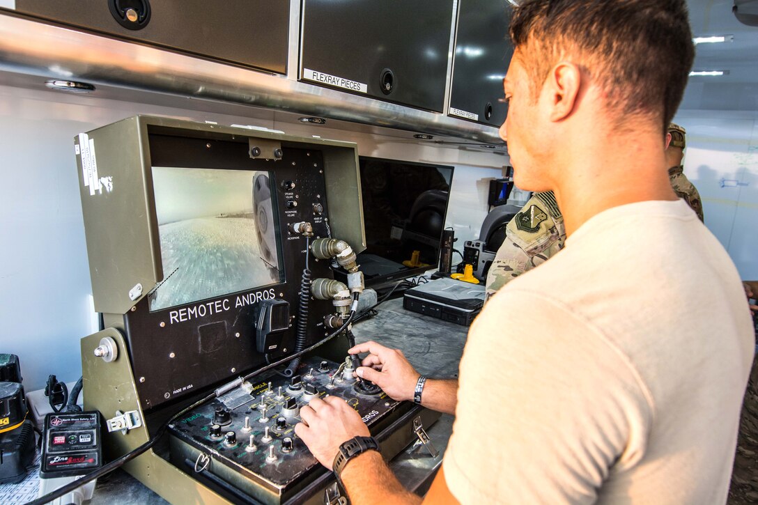 Airman Taylor Lahteine monitors the operations of a Remotec Andros F6A Remote Ordnance Neutralization System during a joint chemical threat training exercise.