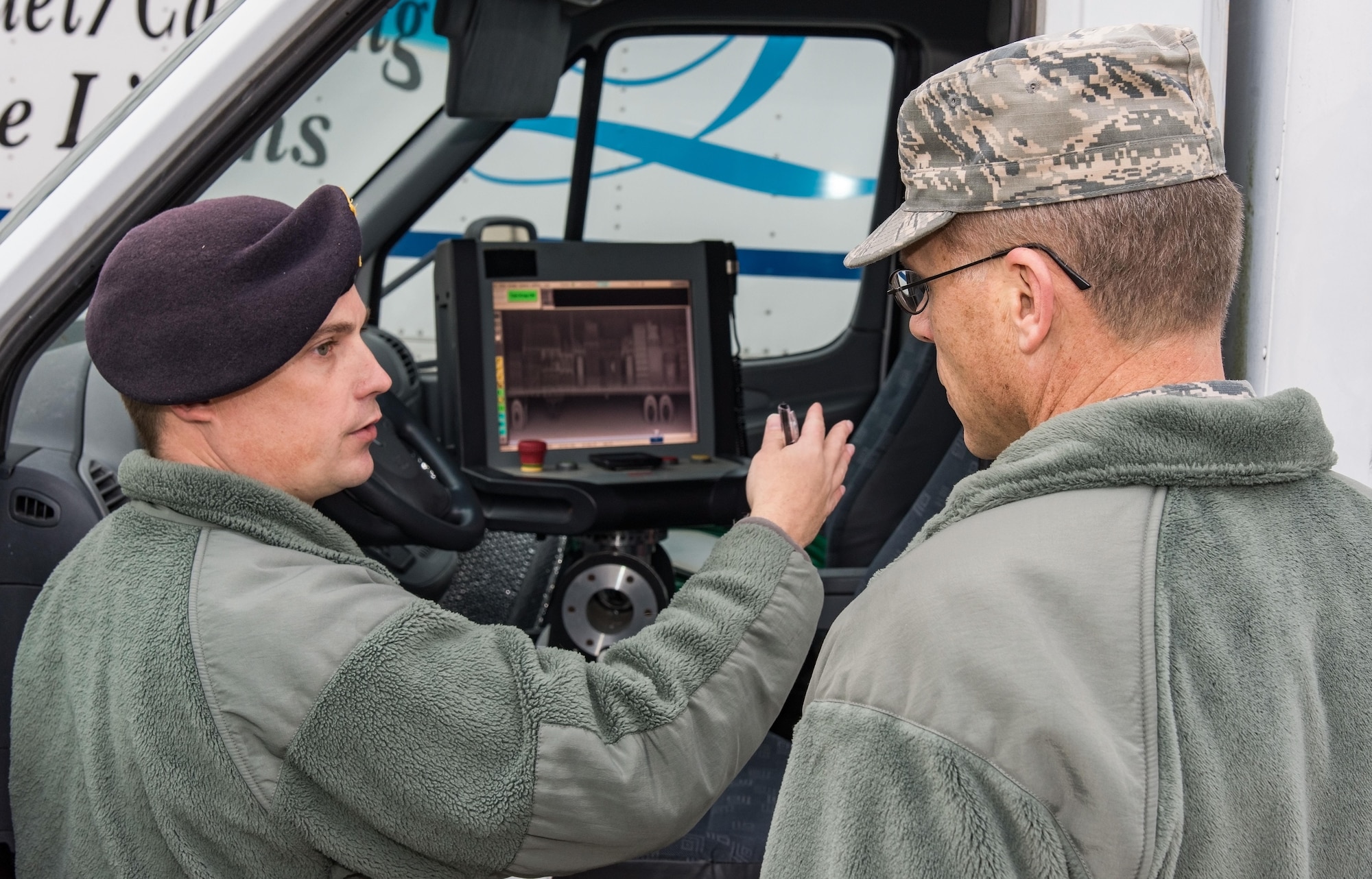 Tech. Sgt. Caleb Ferguson, 436th Security Forces Squadron commercial vehicle inspection gate NCO in charge, shows a saved X-ray of a vehicle to Brig. Gen. Steven Bleymaier, Director of Logistics, Engineering and Force Protection, Headquarters Air Mobility Command, Scott Air Force Base, Ill., Nov. 30, 2017, on Dover Air Force Base, Del. The Backscatter van can X-ray vehicles prior to them entering the Commercial Vehicle Inspection Facility, located near the South Gate. (U.S. Air Force photo by Roland Balik)