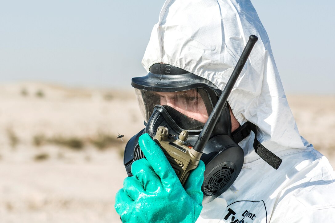 An Airmen uses a radio to communicate his initial findings on an improvised rocket-assisted mortar.