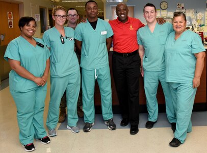 Sgt. Maj. Ronald L. Green (center) takes a group photo with staff members from the U.S. Army Institute of Surgical Research Burn Center Progressive Care Unit.