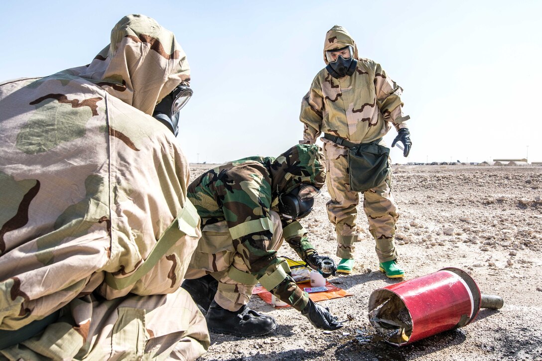 Airmen use an M256A1 chemical agent detector kit to assess a chemical agent during a joint training exercise.