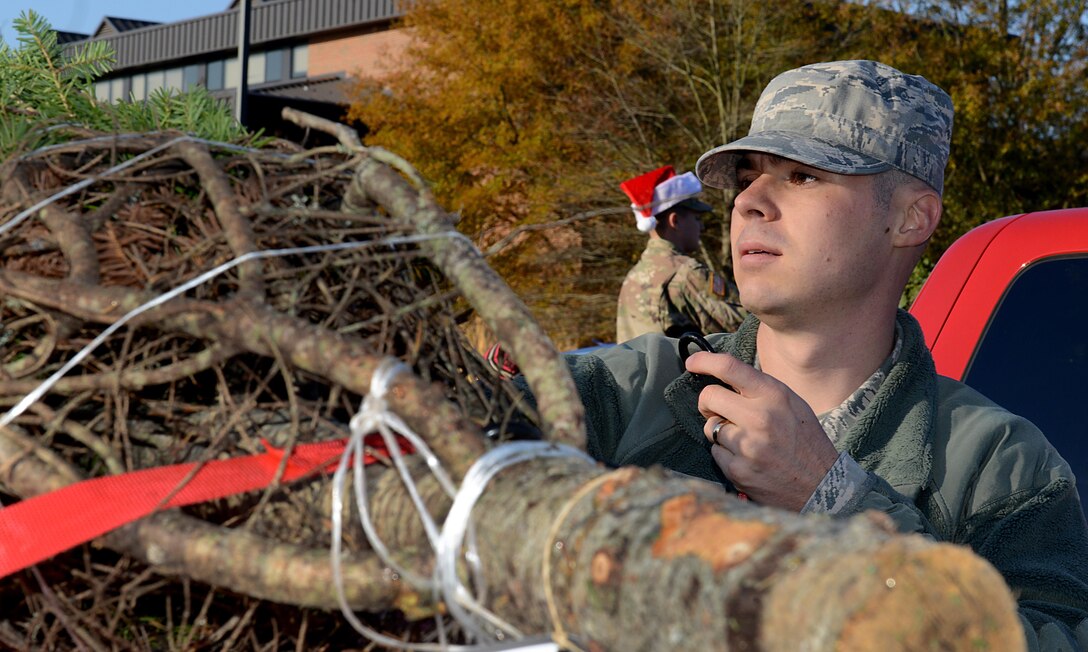 U.S. Air Force Staff Sgt. Cody Bettac, Air Combat Command Headquarters cybersystem operations supervisor, straps a Christmas tree to his vehicle during the Christmas SPIRIT Foundation’s Trees for Troops program at Joint Base Langley-Eustis, Va., Dec. 1, 2017.