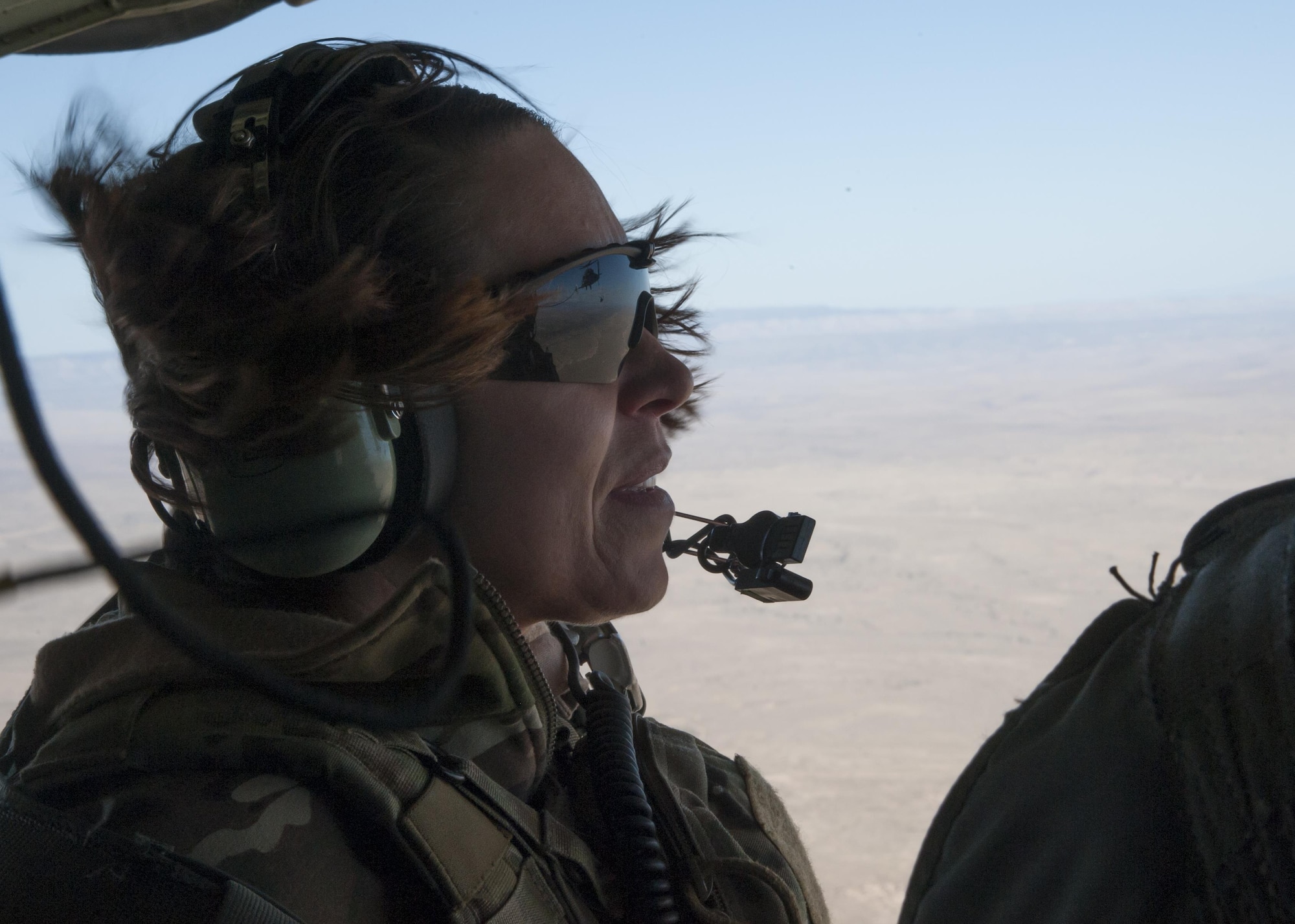 U.S. Air Force Chief Master Sgt. Juliet Gudgel, command chief master sergeant of Air Education and Training Command, watches an HH-60 Pave Hawk refueling training mission at Kirtland Air Force Base, N.M., Nov. 27, 2017. The chief went on four separate flights back-to-back in the course of six hours witnessing a refueling and drop mission in a C-130J, an aerial gunner training in an HH-60 Pave Hawk, hoist training in a CV-22 Osprey and a rescue hoist mission in UH-1H Huey. (U.S. Air Force photo by Staff Sgt. J.D. Strong II)