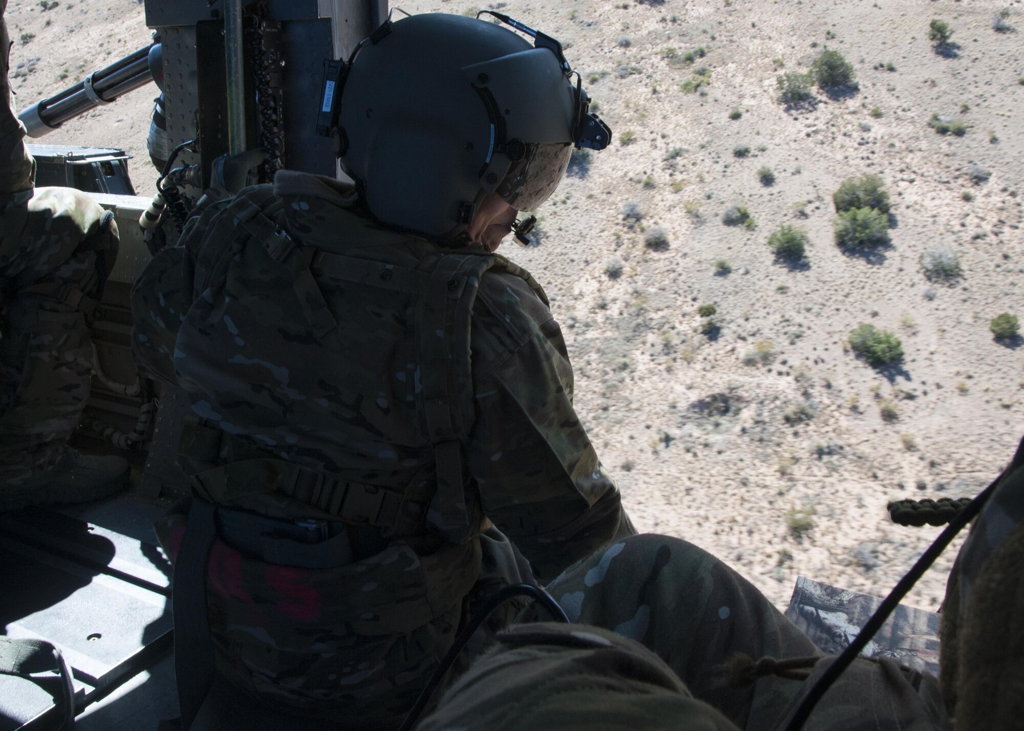 U.S. Air Force Chief Master Sgt. Juliet Gudgel, command chief master sergeant of Air Education and Training Command, watches an aerial gunner training mission at Kirtland Air Force Base, N.M., Nov. 27, 2017. The chief went on four separate flights back-to-back in the course of six hours witnessing a refueling and drop mission in a C-130J, aerial gunner training in an HH-60 Pave Hawk, hoist training in a CV-22 Osprey and a rescue hoist mission in UH-1H Huey. (U.S. Air Force photo by Staff Sgt. J.D. Strong II)