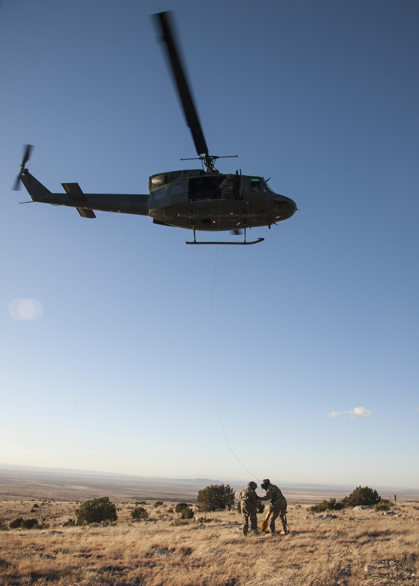 U.S. Air Force Chief Master Sgt. Juliet Gudgel, command chief master sergeant of Air Education and Training Command, is lifted into a UH-1H Huey during a rescue training scenario at Kirtland Air Force Base, N.M., Nov. 27, 2017. Gudgel visited the installation for two days to speak with the Airmen and gain a better understanding of what they do to support the 58th SOW, AETC and Air Force Special Operations Command. (U.S. Air Force photo by Staff Sgt. J.D. Strong II)