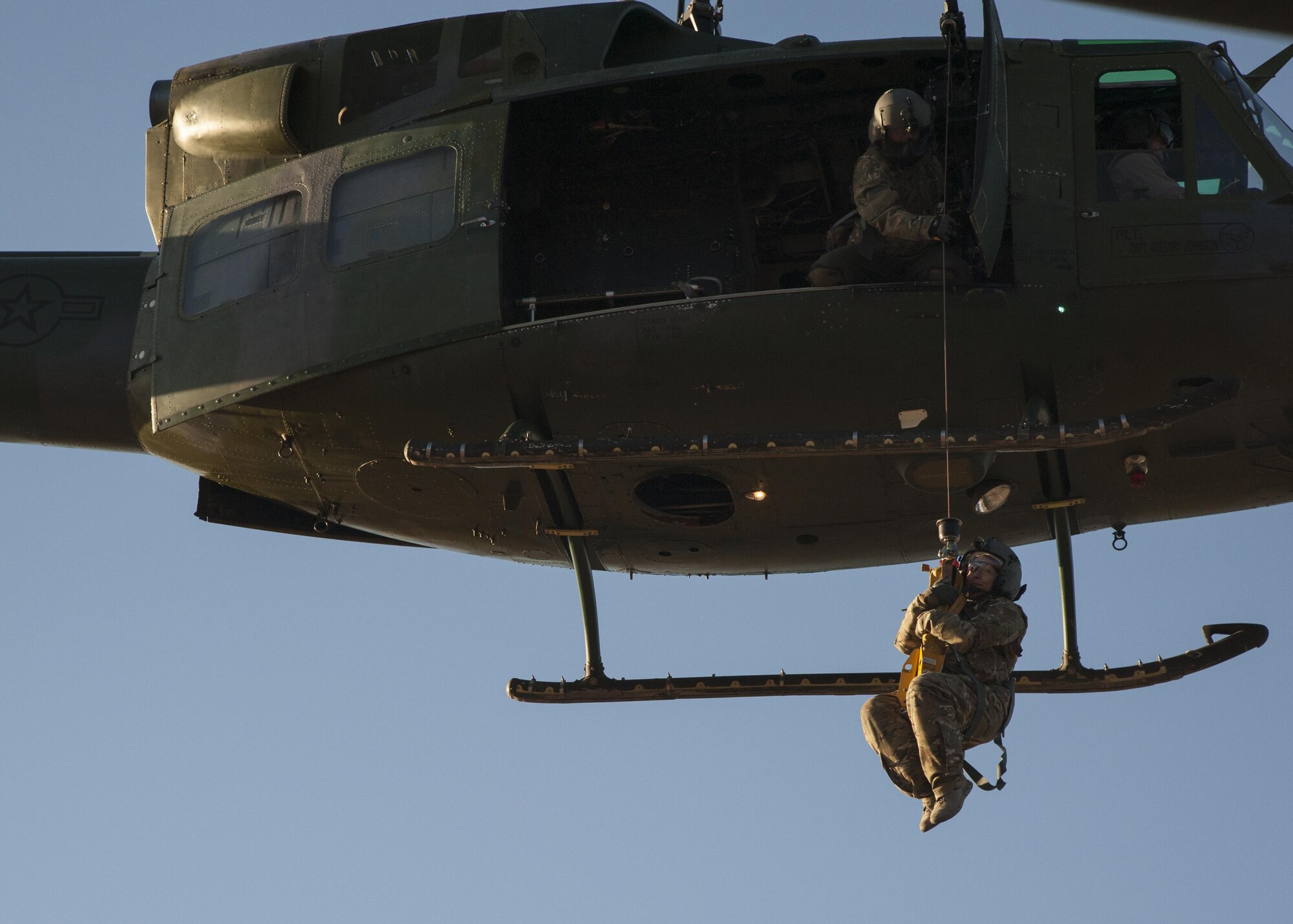 U.S. Air Force Chief Master Sgt. Juliet Gudgel, command chief master sergeant of Air Education and Training Command, is lifted into a UH-1H Huey during a rescue training scenario at Kirtland Air Force Base, N.M., Nov. 27, 2017. On her second day of the visit, Gudgel was able to participate in four training missions with the Airmen of the 58th SOW. (U.S. Air Force photo by Staff Sgt. J.D. Strong II)