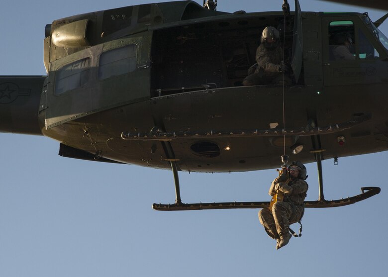 U.S. Air Force Chief Master Sgt. Juliet Gudgel, command chief master sergeant of Air Education and Training Command, is lifted into a UH-1H Huey during a rescue training scenario at Kirtland Air Force Base, N.M., Nov. 27, 2017. On her second day of the visit, Gudgel was able to participate in four training missions with the Airmen of the 58th SOW. (U.S. Air Force photo by Staff Sgt. J.D. Strong II)