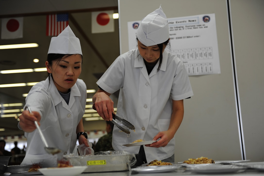 Airmen prepare dish.