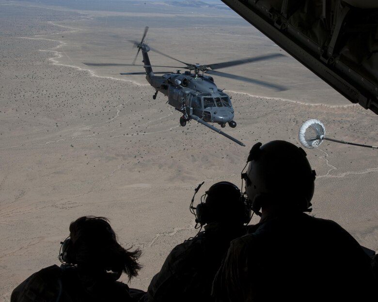 U.S. Air Force Chief Master Sgt. Juliet Gudgel, command chief master sergeant of Air Education and Training Command, watches an HH-60 Pave Hawk refueling training mission at Kirtland Air Force Base, N.M., Nov. 27, 2017. The chief went on four separate flights back-to-back in the course of six hours witnessing a refueling and drop mission in a C-130J, an aerial gunner training in an HH-60 Pave Hawk, hoist training in a CV-22 Osprey and a rescue hoist mission in UH-1H Huey. (U.S. Air Force photo by Staff Sgt. J.D. Strong II)