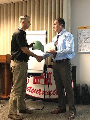 Derek Pommerenck, left, who manages the Environmental Program for Huntsville Center’s Ordnance and Explosives Design Center, is presented a Bronze de Fleury Medal from his former supervisor Thomas Woodie, chief of Savannah District’s Reimbursable Programs and Project Management, during a visit to the Savannah District Oct. 26, 2017.