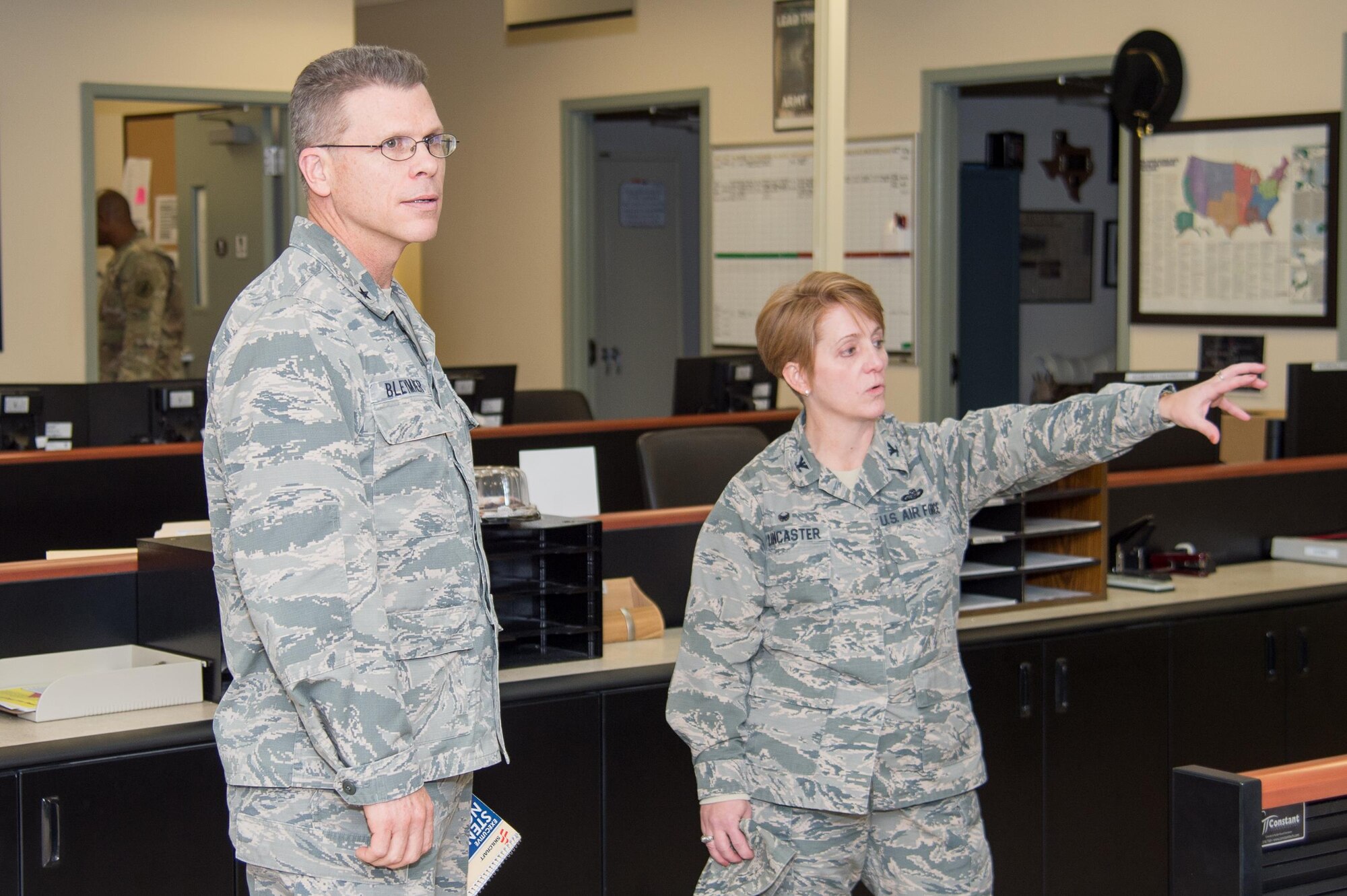 Col. Dawn Lancaster, Air Force Mortuary Affairs Operations commander, gives Brig. Gen. Steven Bleymaier, Director of Logistics, Engineering and Force Protection, Headquarters Air Mobility Command, a tour of the AFMAO command center Nov. 29, 2017, at Dover Air Force Base, Del.