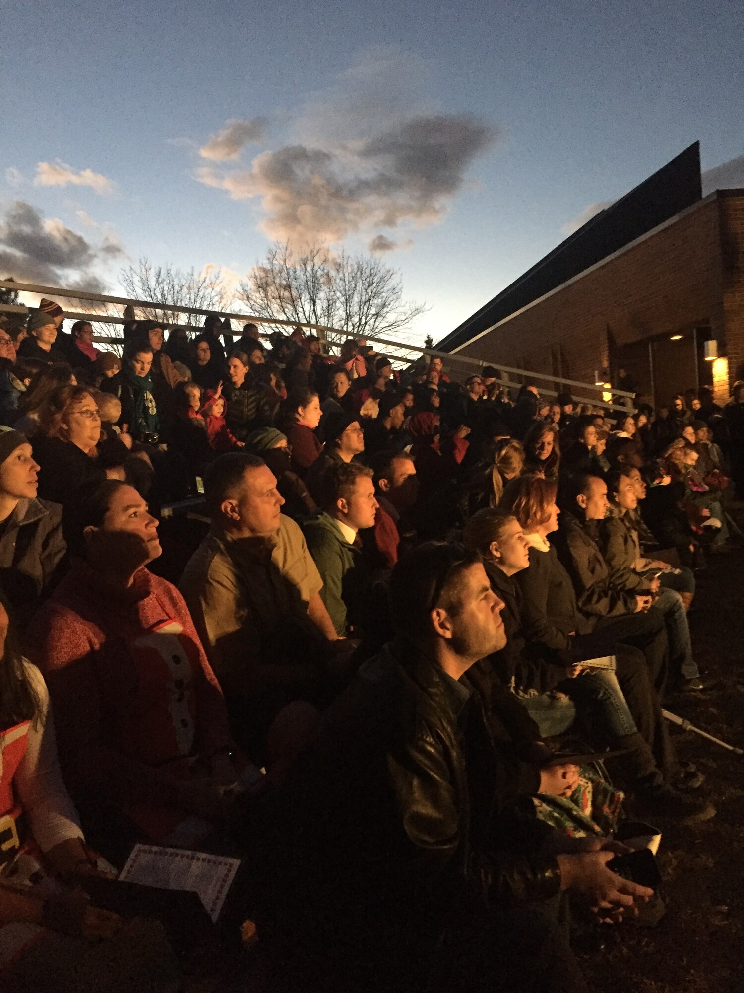 PETERSON AIR FORCE BASE, Colo. — A crowd awaits the flip of the switch at the base holiday tree lighting on Peterson Air Force Base, Colorado, Dec. 1, 2017. Cocoa and cookies were available inside the Chapel after the event. (U.S. Air Force photo by Alethea Smock)