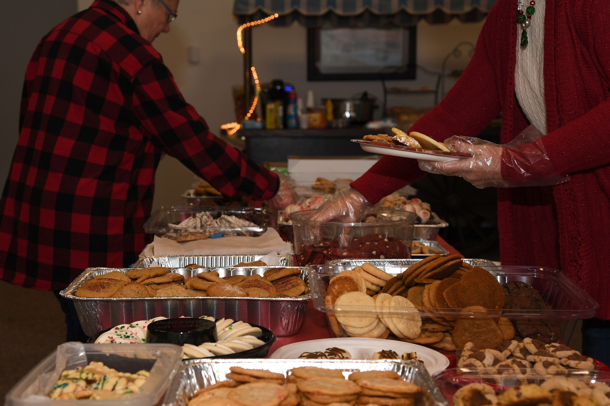 Members of the Spouses Club on base plate cookies at the annual cookie drive in preparation for delivery Dec. 4, 2017, on Grand Forks Air Force Base, N.D. Volunteers customized each plate with an assortment of 12 treats for the Airmen who live in the dorms. (U.S. Air Force photo by Airman 1st Class Elora J. Martinez)