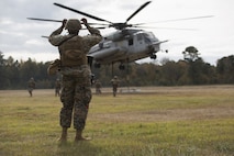 Marines with Combat Logistics Battalion 22 prepare to hook a weighted gear box to a CH-53E Super Stallion for an external lift during helicopter support team training at Camp Lejeune, N.C., Nov. 21, 2017. The training prepares Marines to provide expedient transportation of gear and supplies to units in locations not suited for ground transportation. (U.S. Marine Corps Photo by Pfc. Heather Atherton)