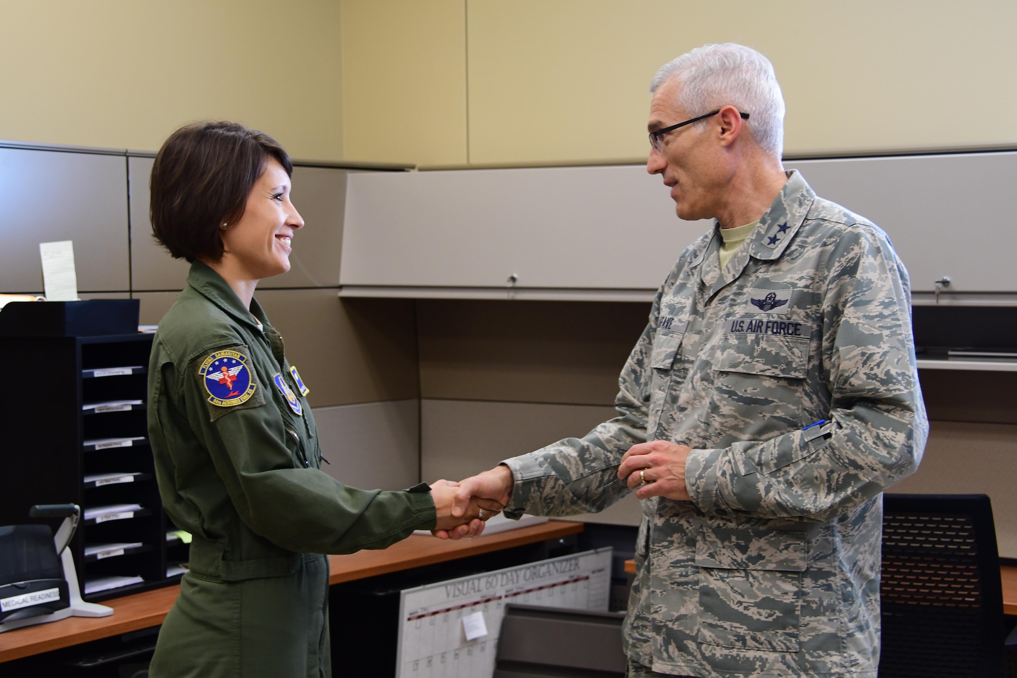 Maj. Gen. Craig La Fave, 22nd Air Force commander, coins Staff Sgt. Kea Hartley, 94th Aeromedical Evacuation Squadron medical technician, at Dobbins Air Reserve Base, Georgia Dec. 2, 2017. Hartley was recognized for her work backfilling as commander support for six months. (U.S. Air Force photo by Staff Sgt. Miles Wilson)