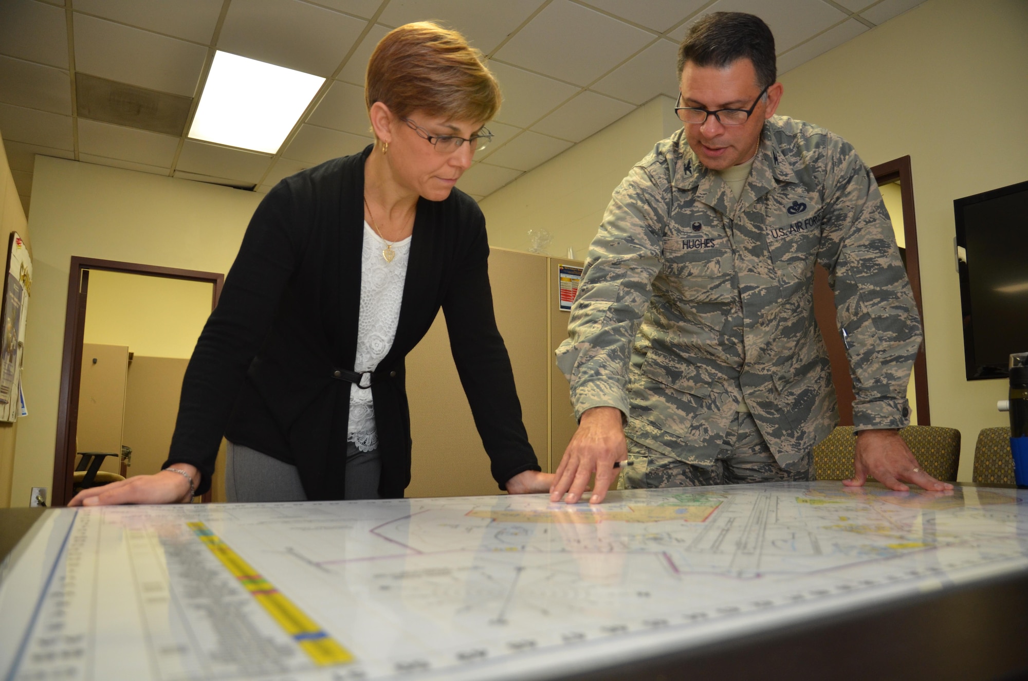 Mrs. Jill La Fave, spouse of Maj. Gen. Craig La Fave, 22nd Air Force commander, looks at a base map with Col. Marty Hughes, 94th Mission Support Group commander, at Dobbins Air Reserve Base, Georgia Dec. 2, 2017. The La Faves and Chief Master Sgt. Clinton Ronan, 22nd AF command chief, visited Reserve Citizen Airmen at the 94th Airlift Wing here during the December drill weekend. (U.S. Air Force photo by Senior Airman Lauren Douglas)