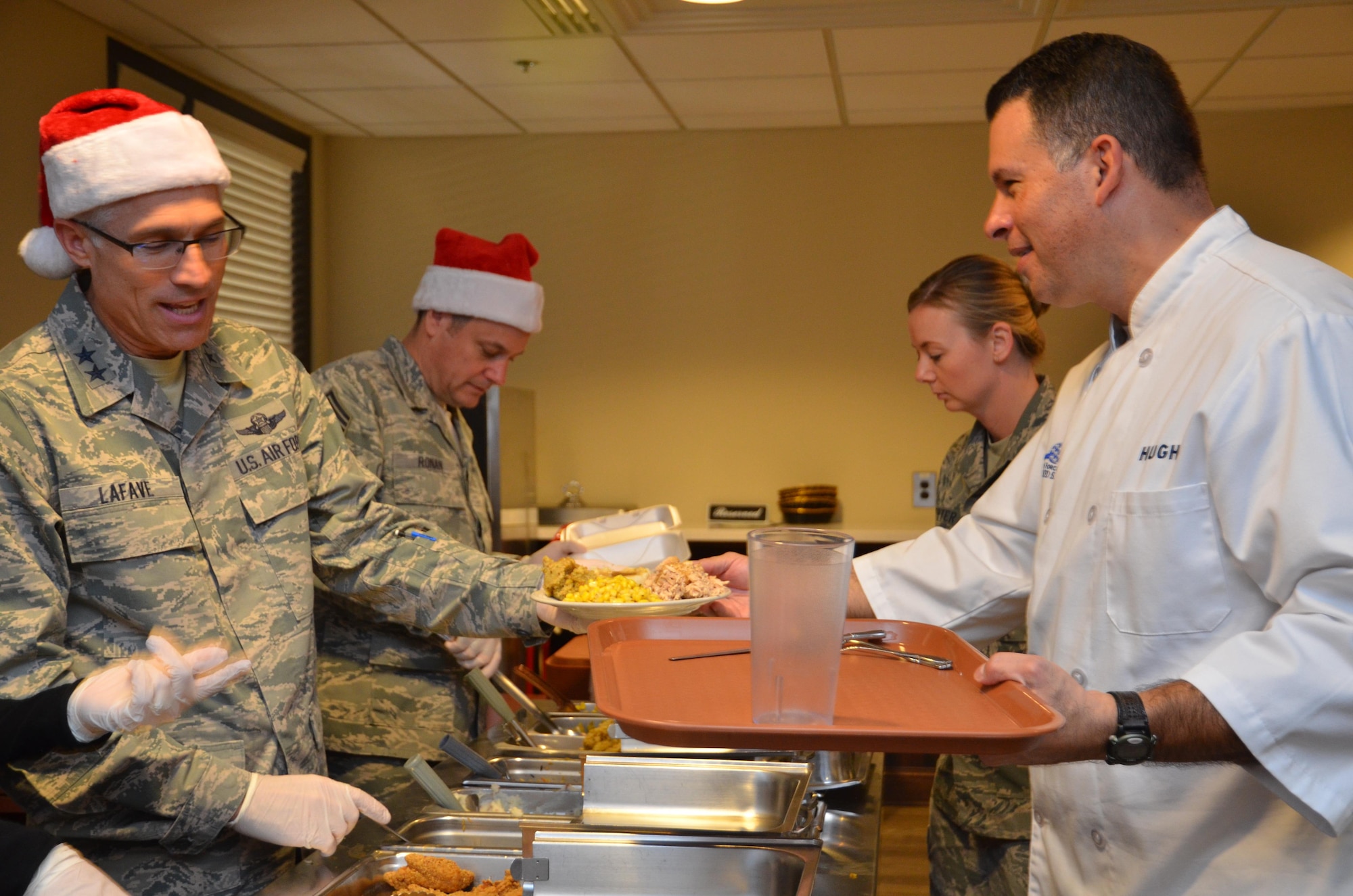 Maj. Gen. Craig La Fave, 22nd Air Force commander, serves holiday meals to Airmen during lunch at Dobbins Air Reserve Base, Georgia Dec. 2, 2017. Afterward, the general sat down for a holiday meal with a group of Airmen. (U.S. Air Force photo by Senior Airman Lauren Douglas)