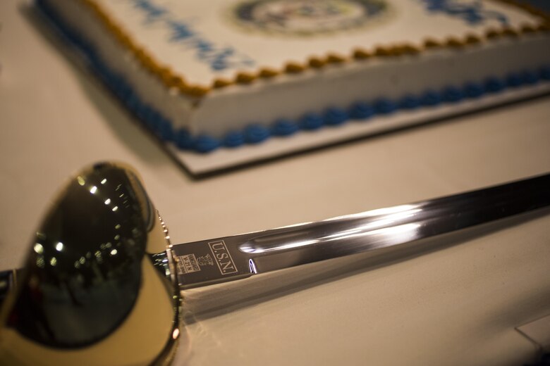 A ceremonial saber is placed in preparation of the cake cutting ceremony at the U.S. Navy Chaplain Corps’ 242nd anniversary celebration, Joint Base Pearl Harbor-Hickam, Dec. 2, 2014. The event featured Rear Adm. Brent Scott, the Chaplain of the Marine Corps, as the guest speaker, and celebrated the Chaplain Corps’ storied history with dinner, music, and traditional Hawaiian dance performances. The celebration also highlighted the important role chaplains play in the emotional and spiritual resiliency of Marines, both forward deployed and in garrison. (U.S. Marine Corps photo by Lance Cpl. Luke Kuennen)