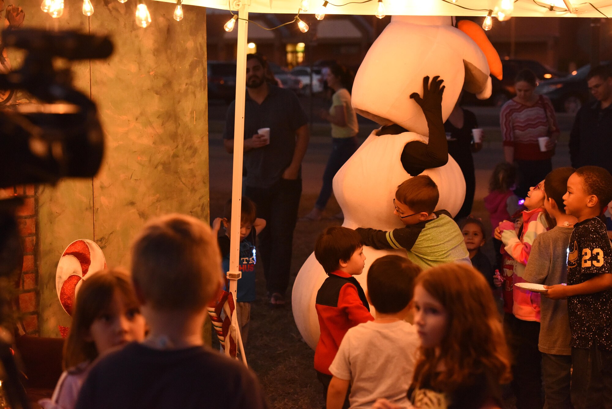 Olaf from the Disney movie Frozen, visits children during the Tree Lighting ceremony at the Parade Field on Goodfellow Air Force Base, Texas, Dec. 4, 2017. Before the festivities took place, children were able to come up and say high as well as play with Olaf. (U.S. Air Force photo by Airman 1st Class Zachary Chapman/Released)