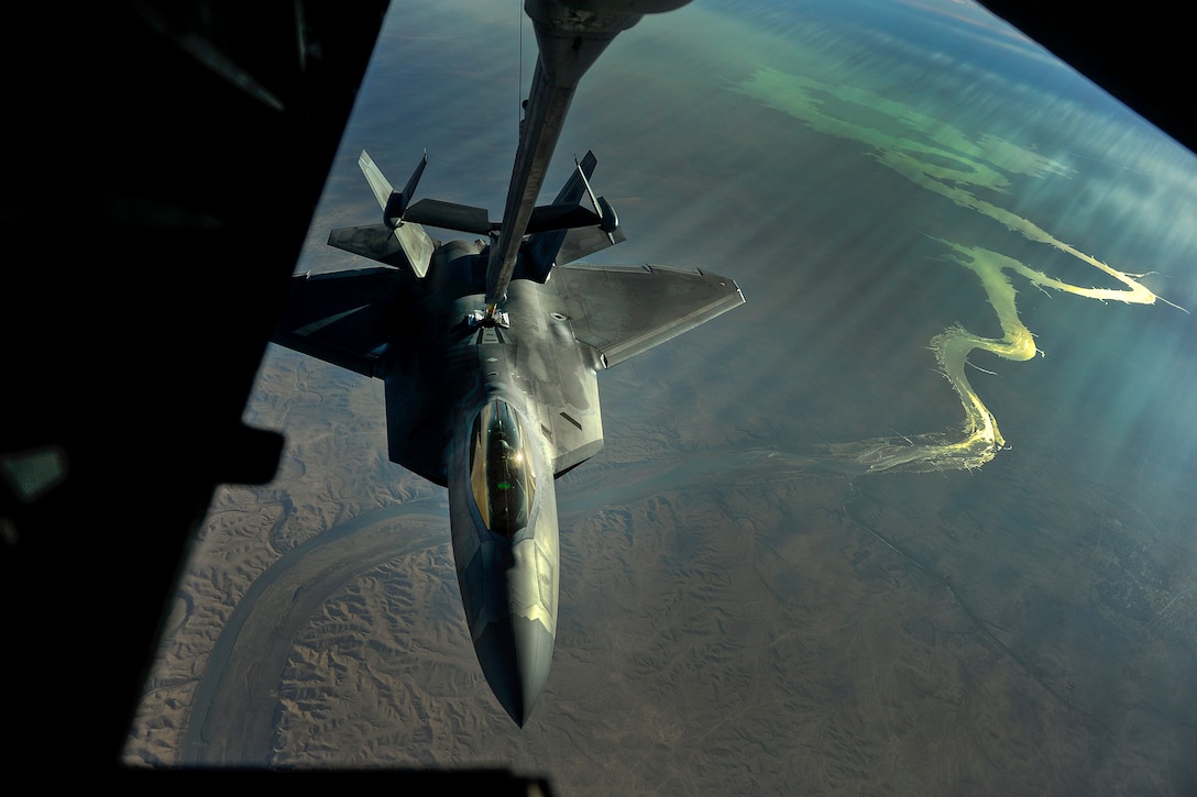 An aircraft receives fuel from another aircraft while in flight.