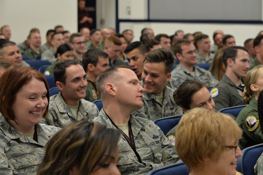 Audience members laugh as retired Lt. Col. Dave Grossman jokes about human interaction Nov. 13, 2017, at Creech Air Force Base, Nev. Grossman visited team Creech to discuss the psychological costs of military service with Airmen who are involved in combat operations on a daily basis. (U.S. Air Force Photo by Airman 1st Class Haley Stevens)