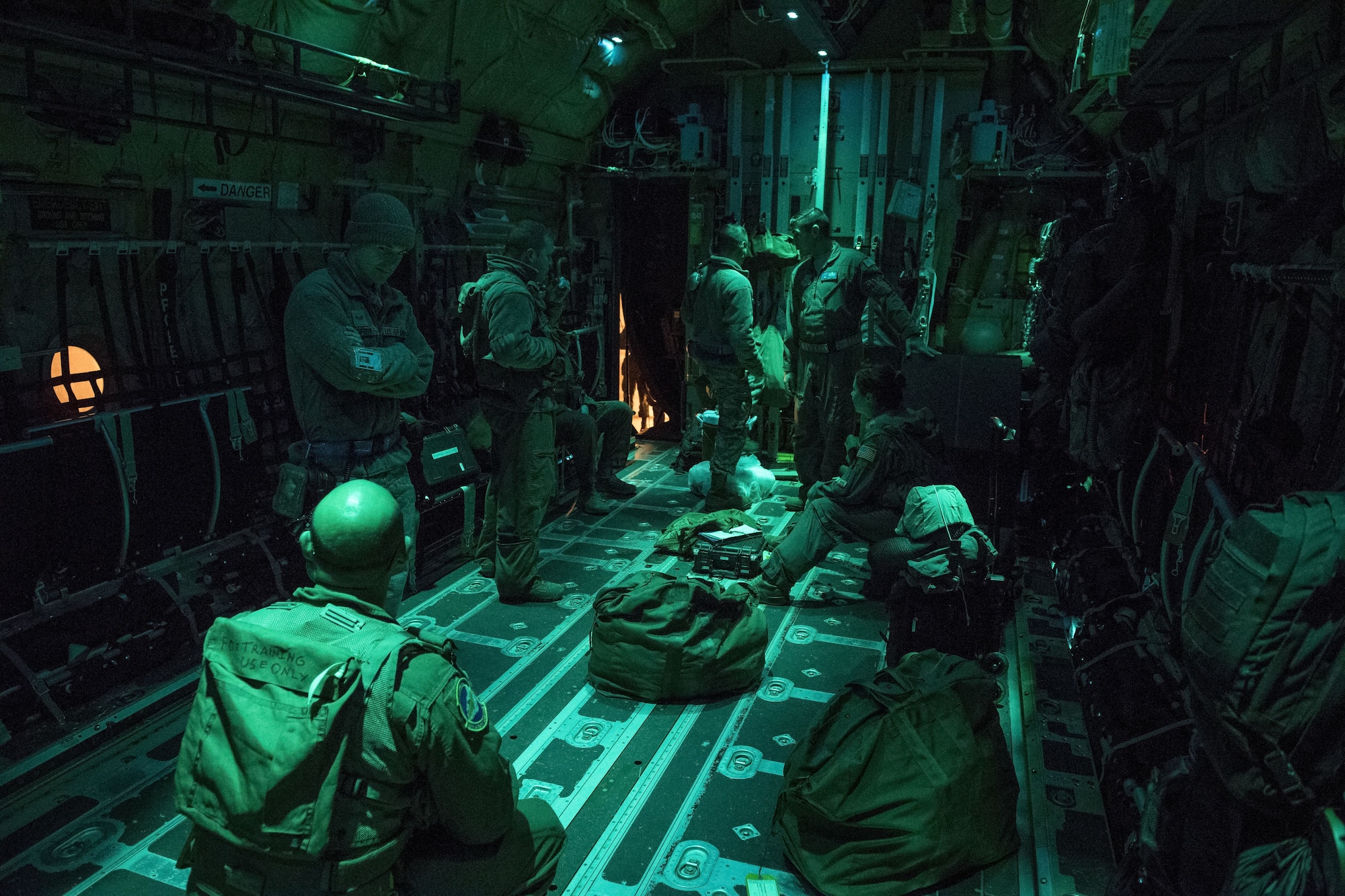 Members of the 40th Airlift Squadron wait inside a C-130J Super Hercules for last minute maintenance before takeoff, Dec, 1, 2017, at Yokota Air Base, Japan.