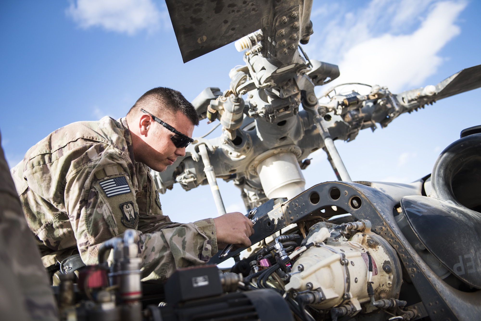 Staff Sgt. Robert Wainright, an HH-60G Pave Hawk crew chief assigned to the
801st Expeditionary Maintenance Squadron, works to replace a pair of
hydraulic lines November 22, 2017, in an undisclosed location. Demanding
desert conditions and in-flight vibrations inherent to helicopters are
especially taxing on aircraft components, which require frequent inspections
to ensure safe operation. (U.S. Air Force photo by Staff Sgt. Joshua
Kleinholz)