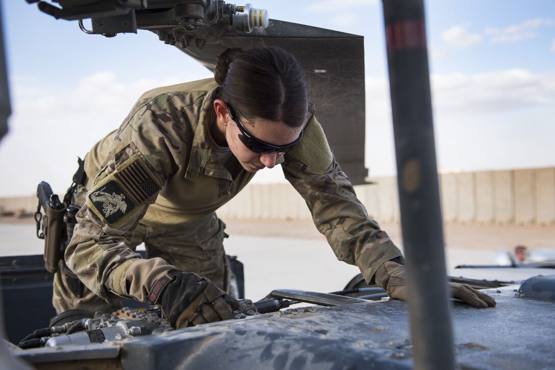 A special missions aviator assigned to 46th Expeditionary Rescue Squadron,
prepares an HH-60G Pave Hawk helicopter for a sortie November 22, 2017, in
an undisclosed location. SMAs are responsible for the inspection and upkeep
of a number of components on the aircraft, as well as the operation of
on-board weapons systems. (U.S. Air Force photo by Staff Sgt. Joshua
Kleinholz)