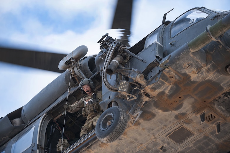 A special missions aviator assigned to 46th Expeditionary Rescue Squadron operates the hoist from an HH-60G Pave Hawk helicopter as part of a training scenario November 22, 2017, in an undisclosed location.  The 46th ERQS provides combat search and rescue capabilities across the region in support of Operation Inherent Resolve. (U.S. Air Force photo by Staff Sgt. Joshua Kleinholz)