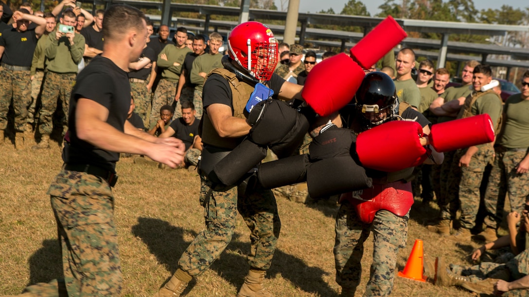 Marines with 2nd Transportation Support Battalion, 2nd Marine Logistics Group battle one another with pugil sticks during 2nd TSB’s Commander’s Cup 2017 at Camp Lejeune, N.C., Dec. 1, 2017. The competition included an obstacle course, assembly and disassembly of the M240B medium machine gun, maneuver under fire course, tire flip relay race, log tossing, Tug o’ War and pugil stick battle. The Marines improved their physical fitness and strengthening their unit.