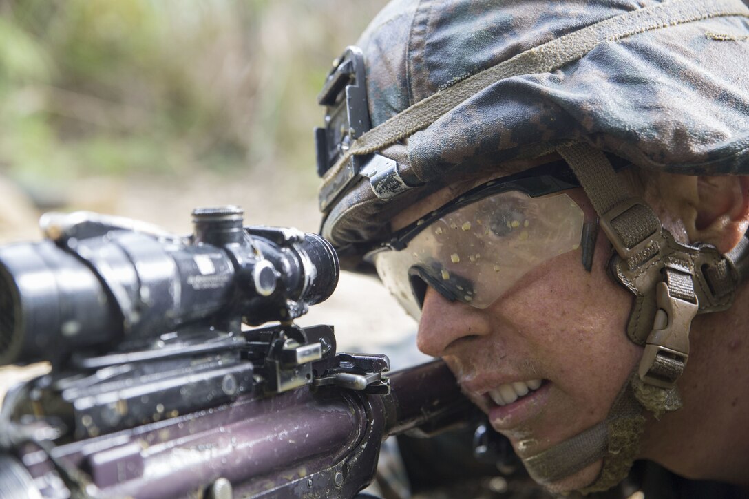 Petty Officer 1st Class Holden Hartley, a corpsman with Combat Assault Battalion, 3rd Marine Division, III Marine Expeditionary Force, provides security as his squad finishes up their objective December 6, 2017, at the Jungle Warfare Training Center in Okinawa, Japan while participating in the 3rd Marine Division Annual Squad Competition. The squads competing  are with 1st Battalion, 8th Marine Regiment; 2nd Battalion, 1st Marine Regiment; 1st Battalion, 3rd Marine Regiment and Combat Assault Battalion.  Hartley is a native to Vacaville, California.