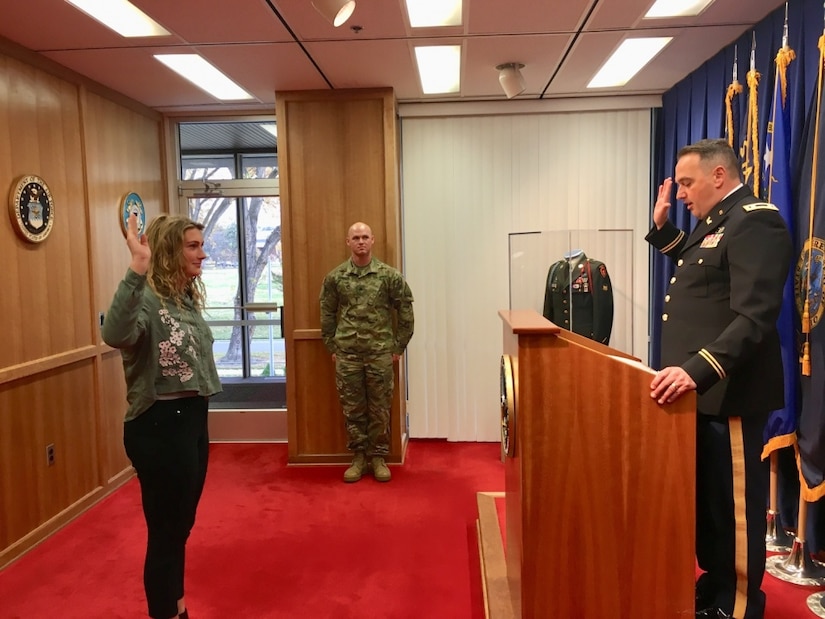 An Army officer swears in an enlistee