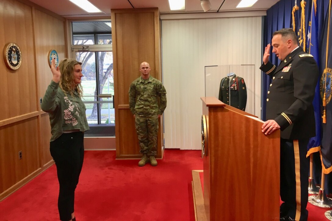 A woman is sworn in as a member of the National Guard.
