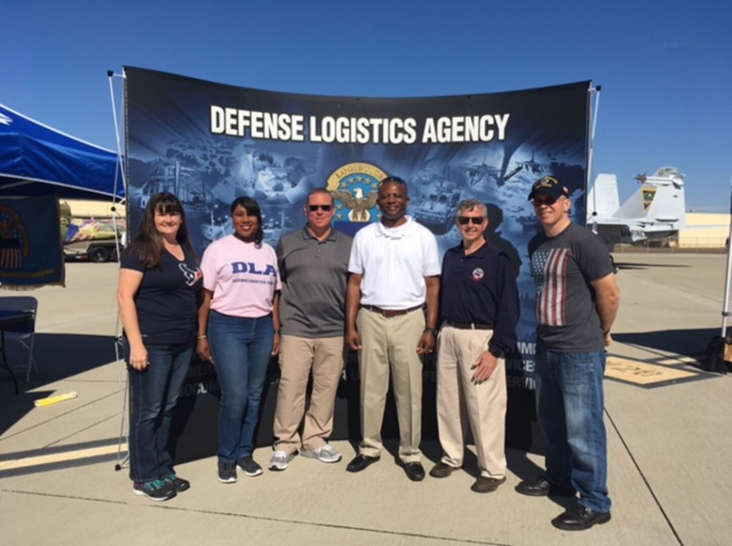 Representatives from DLA Distribution San Diego, California, participate in the Naval Air Station North Island 100th anniversary event. (left to right: Mrs Brian Meadows, Stella Nealy, Brian Meadows, Navy Capt. Jerome R. White, Darrell “Amos” Moses and Navy Lt. Cmd. Brendan R. Hogan)