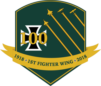 Logo and coin design created for the 1st Fighter Wing’s 100th Anniversary. The design features colors and elements from the 1st FW emblem. It also includes four aircraft, a U.S. Air Force F-15 Eagle, F-22 Raptor, P-38 Lightning and Nieuport 28, which represents the legacy of the 1st FW.