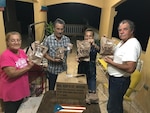 Family, facing viewer, holding MREs