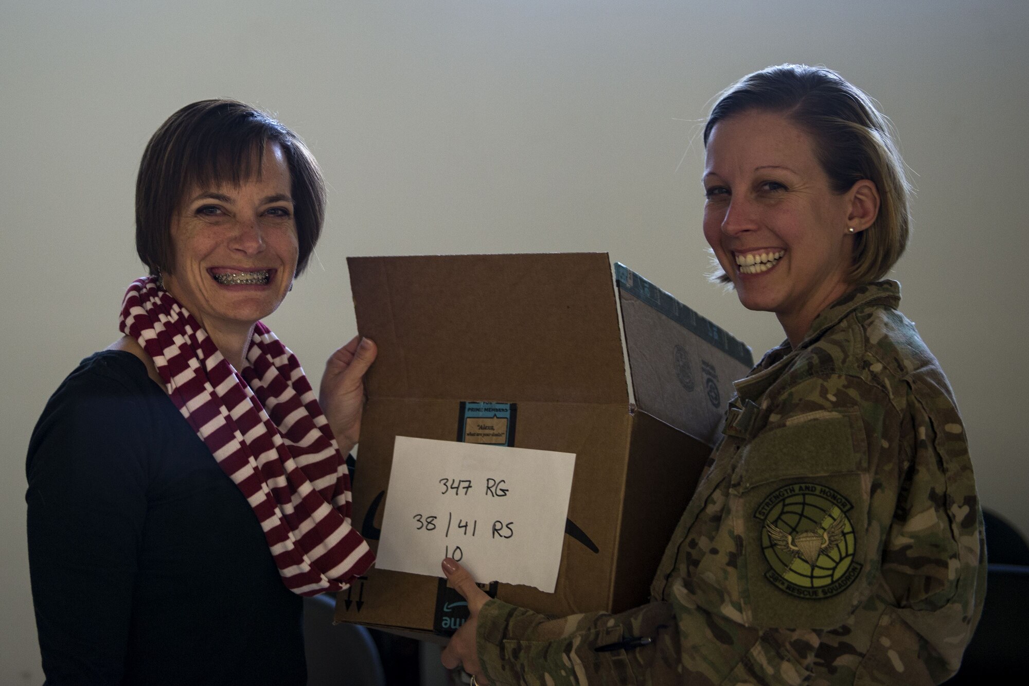 Stacey Gingrich, left, spouse of Col. Jason Gingrich, 347th Rescue Group commander, and Master Sgt. Stephanie Ruepp, 38th Rescue Squadron unit training manager, pose for a photo during the Annual Moody Airmen Cookie Drive, Dec. 4, 2017, at Moody Air Force Base, Ga. Local organizations, Airmen and spouses donated more than 8,000 cookies to approximately 700 dorm residents to show appreciation for the Airmen during the holidays. (U.S. Air Force photo by Airman 1st Class Erick Requadt)