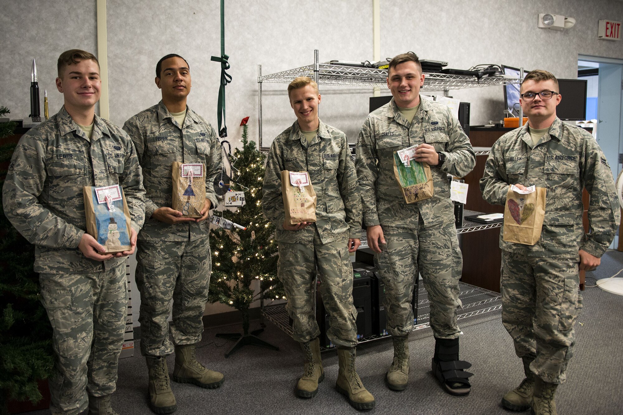 Airmen assigned to the 23d Communications Squadron pose for a photo during the Annual Moody Airmen Cookie Drive, Dec. 5, 2017, at Moody Air Force Base, Ga. Local organizations, Airmen and spouses donated more than 8,000 cookies to approximately 700 dorm residents to show appreciation for the Airmen during the holidays. (U.S. Air Force photo by Airman 1st Class Erick Requadt)