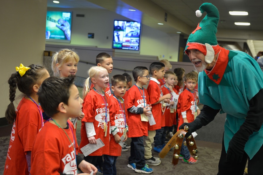 Children from Luke Air Force Base sing a Christmas song while being entertained by volunteers during the United Fantasy Flight at the Phoenix Sky Harbor International Airport in Phoenix Ariz., Dec. 1, 2017. Dozens of children from around Phoenix received shoes, sweatshirts, blankets, toys, books and a tablet courtesy of United Airlines. (U.S. Air Force photo/Senior Airman Devante Williams)