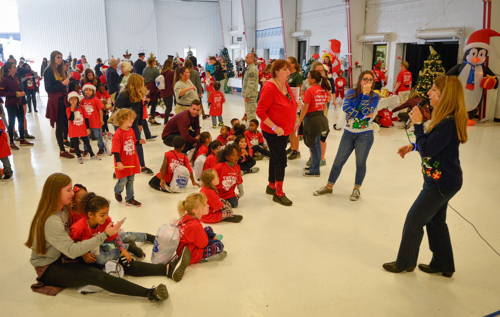 Team Luke children along with elementary students throughout Phoenix participate in the United Fantasy Flight at the Phoenix Sky Harbor International Airport in Phoenix Ariz., Dec. 1, 2017. United Airlines flew dozens of kids on a flight to a simulated North Pole. (U.S. Air Force photo/Senior Airman Devante Williams)